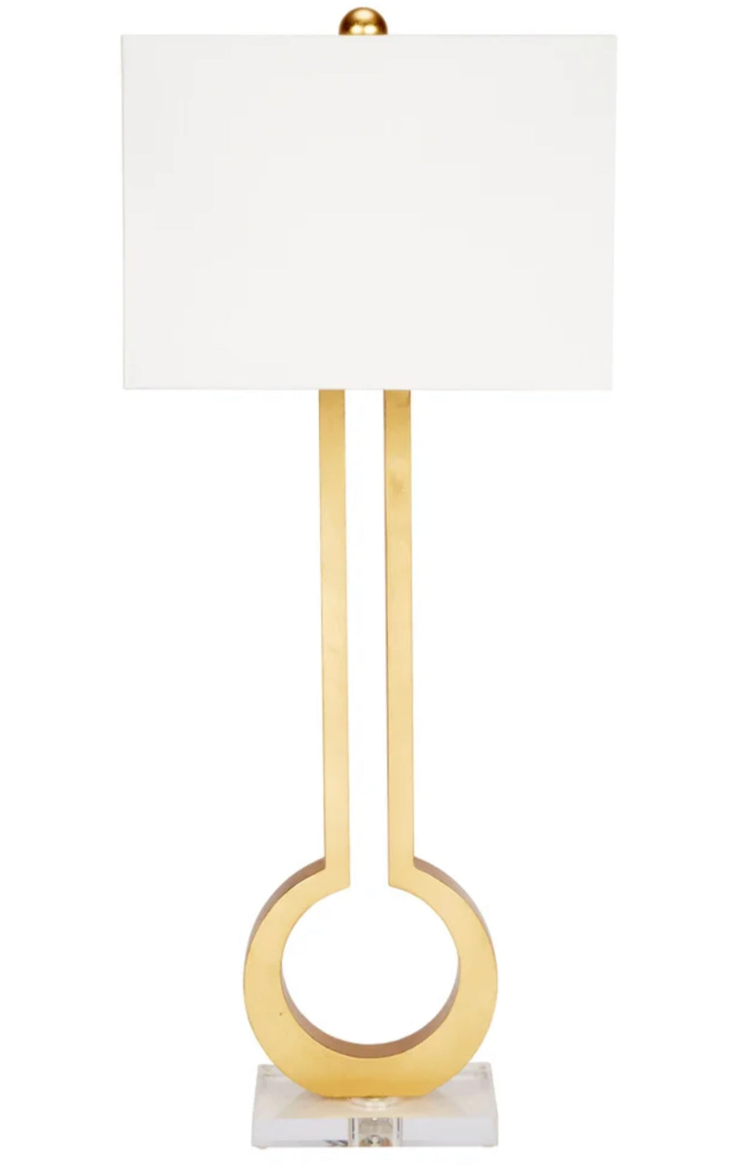 The Guthrie Table Lamp boasts an elegant design, featuring an open key design and lucite base, topped with a white linen shade. It's a stunning addition to any room, providing both style and functionality.